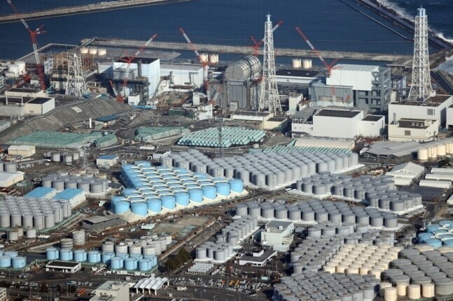 Japan plans to release into the ocean the 1.33 million metric tons of radioactive water stored in tanks, shown here, at the Fukushima Daiichi nuclear power plant over the course of 30 years. (AP/Yonhap)