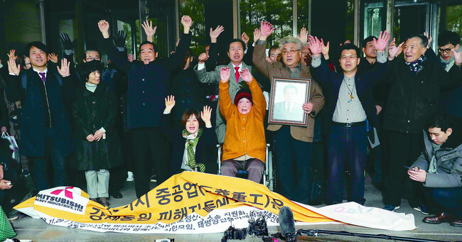 Forced labor victims and their families celebrate their victory in a lawsuit against Mitsubishi in a Supreme Court case on Nov. 29