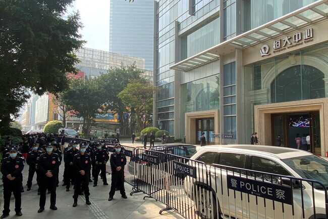 In January 2022, police stand guard outside of Evergrande’s offices in Guangzhou amid protests by people calling for their money back. (Reuters)