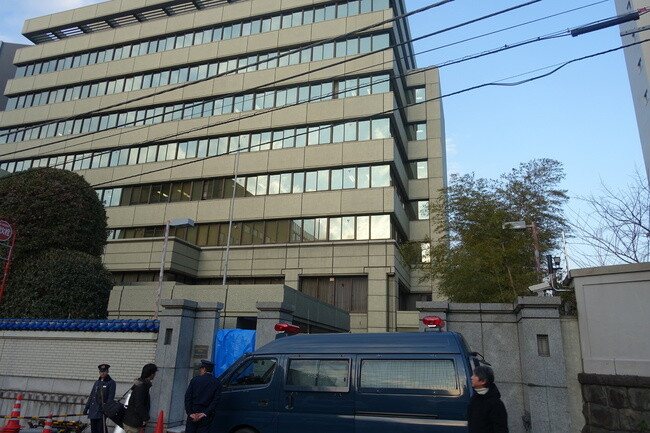 Police gather outside the main entrance of the General Association of Korean Residents in Japan