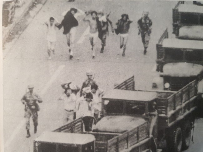 Martial law troops march civilians down the street after stripping them down to their underwear. (provided by the May 18 Memorial Foundation)
