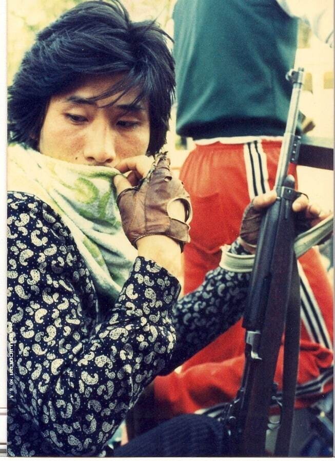 A member of Gwangju’s citizen militia sits in a car with his carbine rifle during the Gwangju Democratization Movement of May 18, 1980.