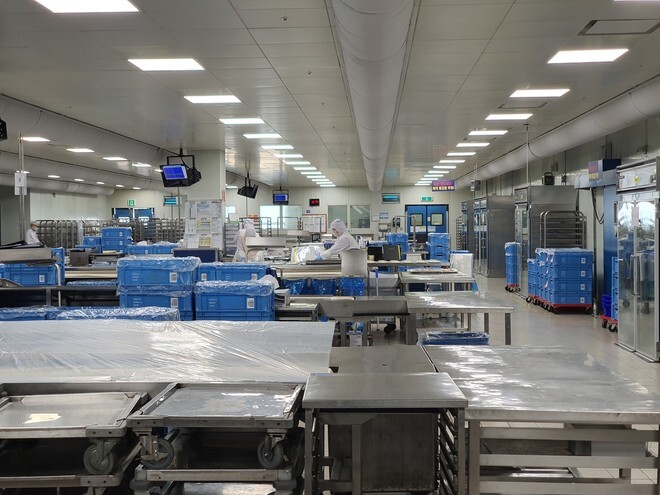 The meal production center’s dishing department is operating only two out of its original 20 teams.
