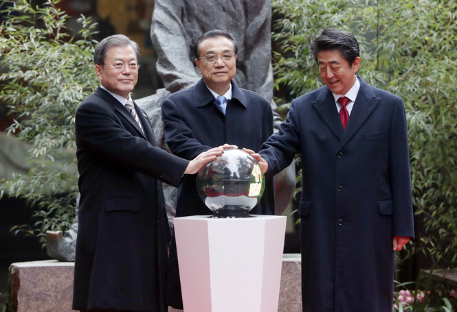 South Korean President Moon Jae-in, Chinese Premier Li Keqiang, and Japanese Prime Minister Shinzo Abe attend a ceremony unveiling a monument celebrating 20 years of cooperation between their three countries at the Du Fu Thatched Cottage in Chengdu, in China’s Sichuan Province, on Dec. 24.
