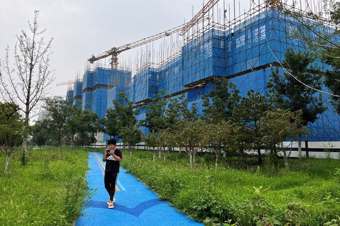 A person walks by a Country Garden development site in Beijing, China, on Aug. 11. (Reuters/Yonhap)
