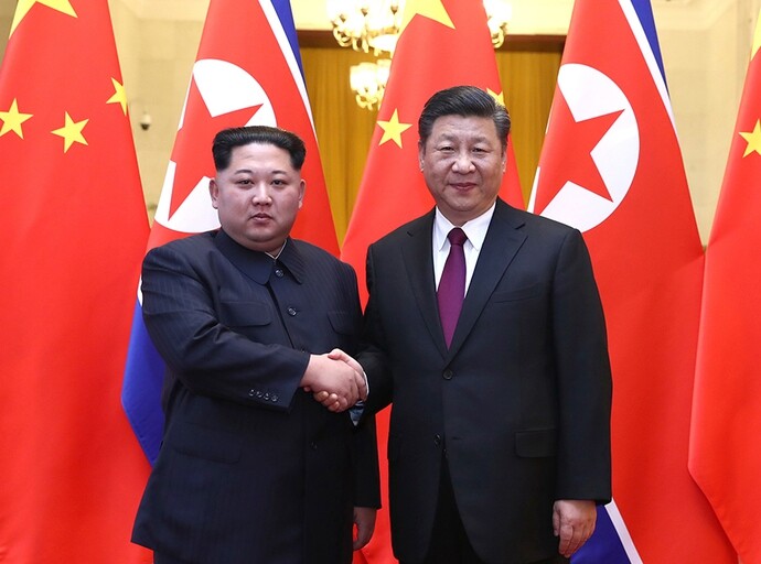 North Korean leader Kim Jong-un shakes hands with Chinese President Xi Jinping prior to their summit at the Great Hall of the People in Beijing on Mar. 26. The photo was issued by Chinese state media on Mar. 28. (Xinhua)