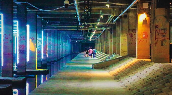 People walking through the tunnel along Hongje Stream