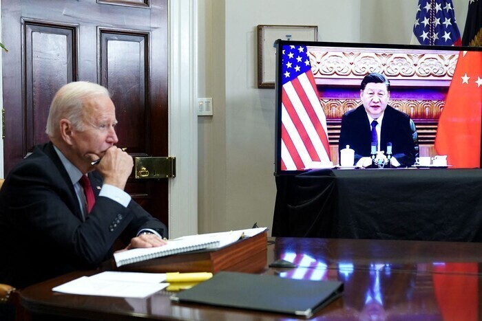 US President Joe Biden takes part in a virtual summit with Chinese President Xi Jinping on Monday from the Roosevelt Room of the White House. This was the first meeting of the two leaders since Biden was inaugurated 10 months ago. (AFP/Yonhap News)