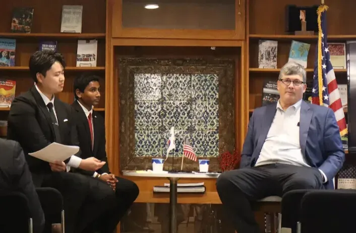Yohan Moon and Anirudh Prakash, the president and vice president of SFS Korea Policy Club at Georgetown University, respectively, host a fireside chat with Mark Lambert. (courtesy of the Korea Policy Club)