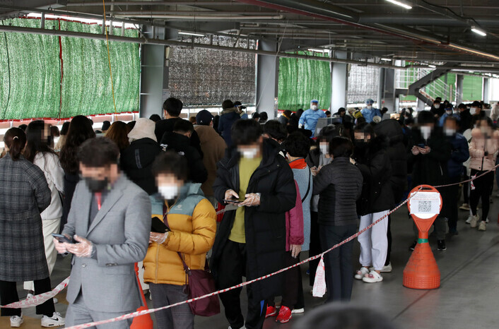 People wait in line to be tested for COVID-19 outside of a screening station in northern Gwangju on Tuesday. (Yonhap News)