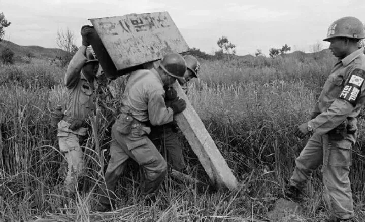 South Korean soldiers place a sign designating the Military Demarcation Line separating the two Koreas following the Korean War. (courtesy Defense Daily)