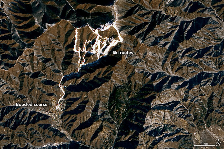 A satellite view of the Olympic facilities in the Yanqing District of Beijing shows routes made from artificial snow. (provided by NASA)