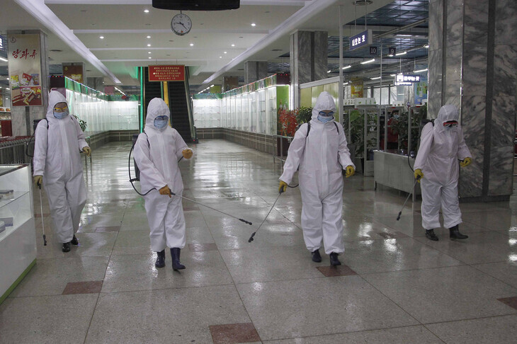 Public health workers disinfect a department store in Pyongyang, North Korea. (AP/Yonhap News)