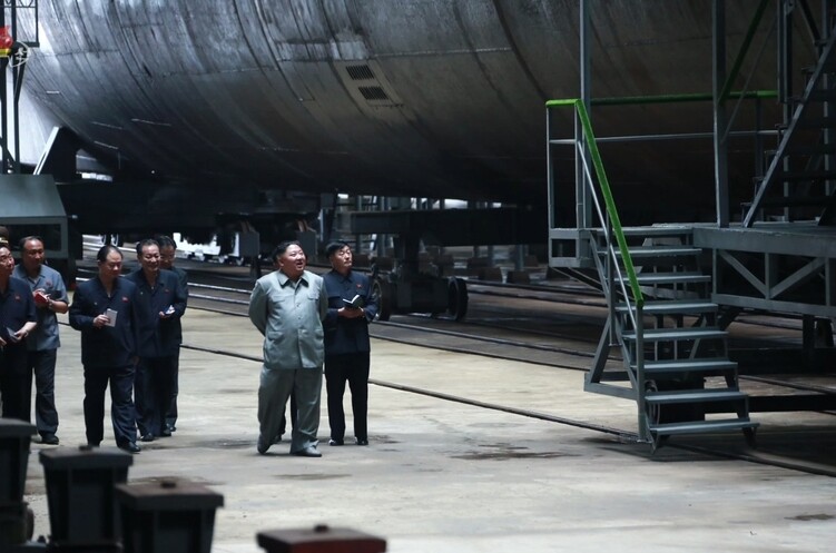 North Korean leader Kim Jong-un reviews a newly built submarine on July 23. (KCTV/Yonhap News)
