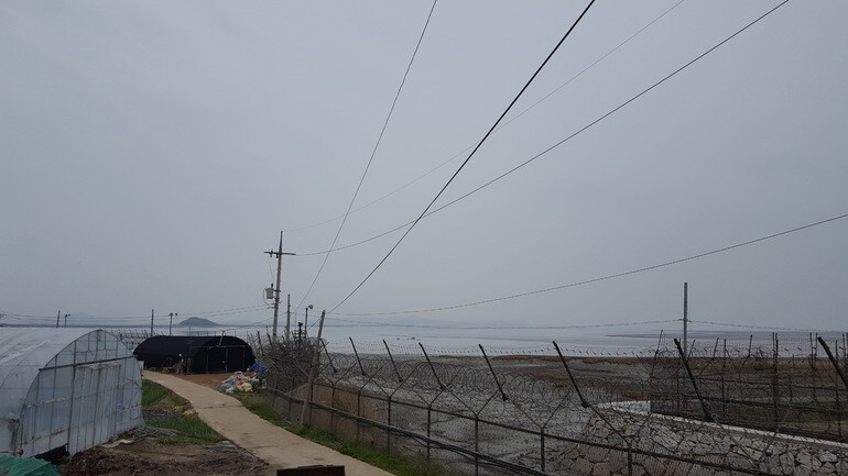 A fence of barbed wire blocks off the northern coast of Gyodong Island