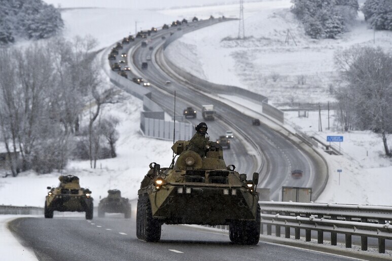 A procession of Russian troops in armored cars makes its way down a highway in the peninsula of Crimea, near Ukraine, on Jan. 18. In 2014, Russia annexed Crimea by force. (AP/Yonhap News)