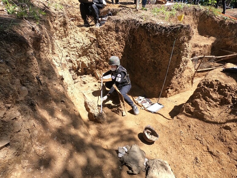 South Korean soldiers work to exhume the remains of fallen soldiers on Hwasalmeori (Arrowhead) Hill in Cheorwon County