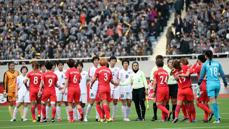 The South and North Korean women’s soccer teams shake hands after playing to a 1-1 draw in their World Cup Qualifier and Asian Cup at Kim Il-sung Stadium in Pyongyang