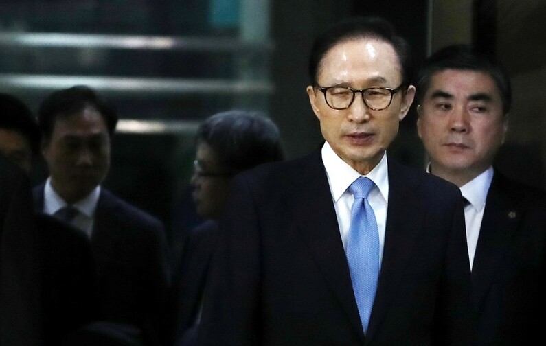 Former president Lee Myung-bak leaves the Seoul Central District Prosecutors’ Office on the morning of Mar. 15 following a 21-hour questioning session by prosecutors. (Photo Pool)