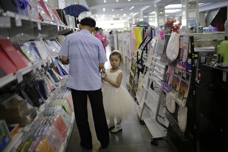 A father and daughter shopping at a Pyongyang department store.