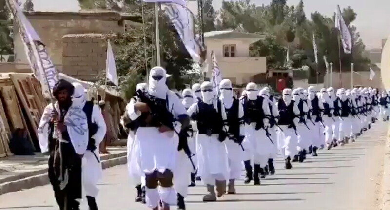 Uniformed Taliban fighters march on the street in Qalat, Zabul Province, Afghanistan, in this still image taken from a video uploaded to social media on Aug. 19. (Reuters/Yonhap News)