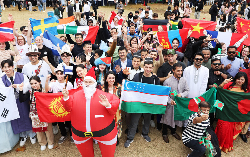 International students at Ajou University in Suwon, Gyeonggi Province, pose for a photo at an event for “Ajou International Day” on Nov. 9, 2023. (Yonhap)