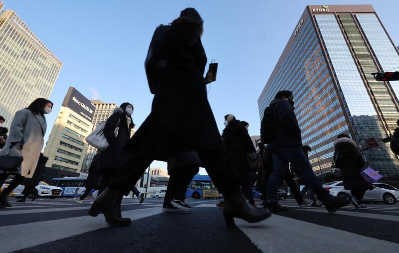 People make their way across a street in downtown Seoul on March 3. (Yonhap News)
