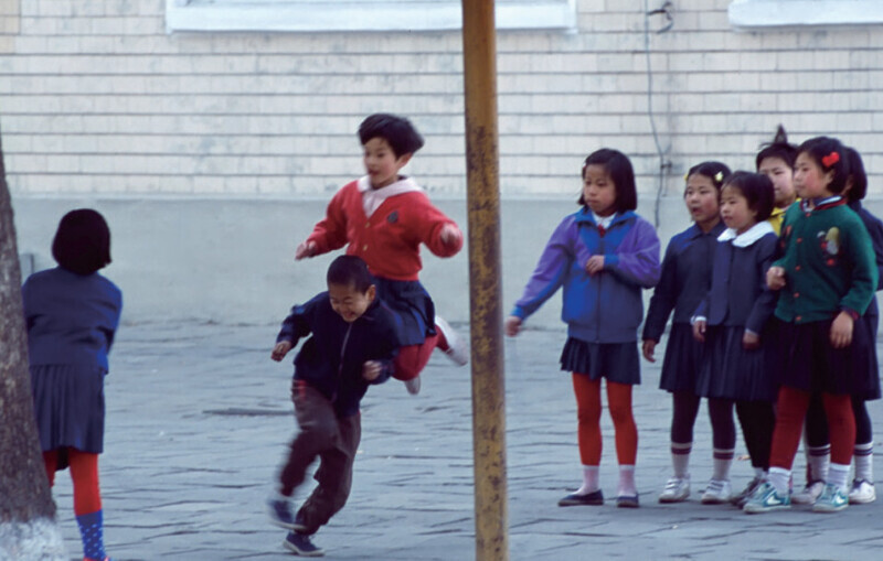 North Korean children frolic as they play in the streets of their neighborhood. (Lim Jong-jin)
