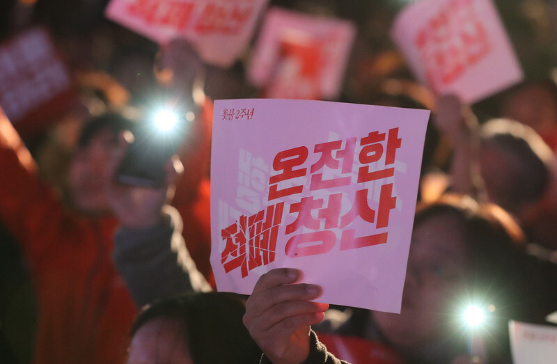 Demonstrators celebrate the second anniversary of the candlelit rallies that helped drive then President Park Geun-hye from office on Oct. 27 in Seoul’s Gwanghwamun Plaza. Demonstrators can be seen holding signs calling for the “complete eradication of deep-rooted vices.” (Shin So-young