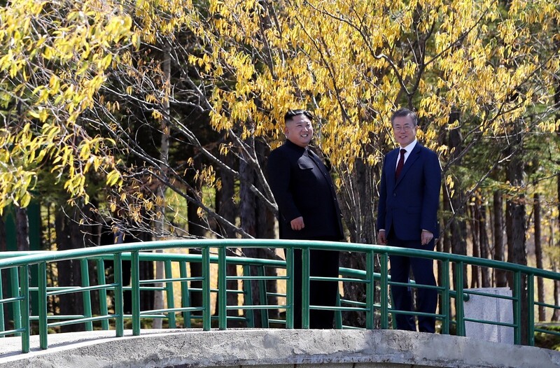South Korean President Moon Jae-in and North Korean leader Kim Jong-un take walk along a bridge over Samji Pond near Mount Baekdu. (photo pool)