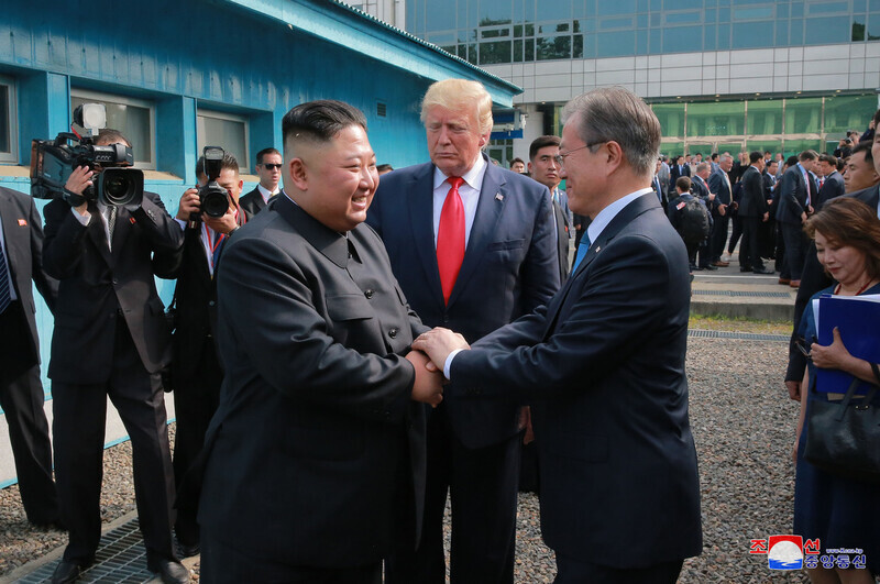 North Korean leader Kim Jong-un (left) greets South Korean President Moon Jae-in during their meeting in Panmunjom in 2019. Donald Trump of the US stands behind the leaders of the two Koreas. (KCNA)