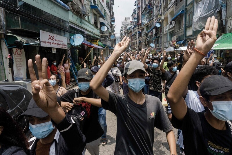 Anti-coup protesters make the three-finger salute as they march in Yangon, Myanmar, Tuesday. (AFP/Yonhap News)