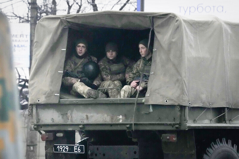 Ukrainian soldiers ride in a military vehicle on the outskirts of Mariupol in the country’s southeast on Feb. 24. (AP/Yonhap News)