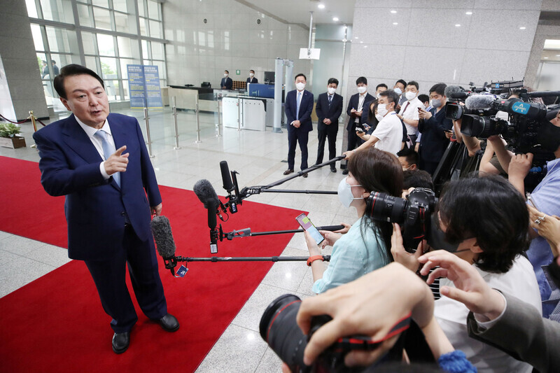 President Yoon Suk-yeol answers questions from the press as he heads to work at his Yongsan office on July 5. (Yonhap News)