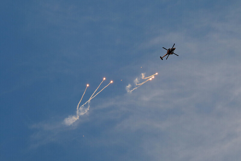 An Israeli military helicopter shoots off flares amid an IDF attack on a refugee camp in Jenin, Palestine, on March 7. (Xinhua/Yonhap)
