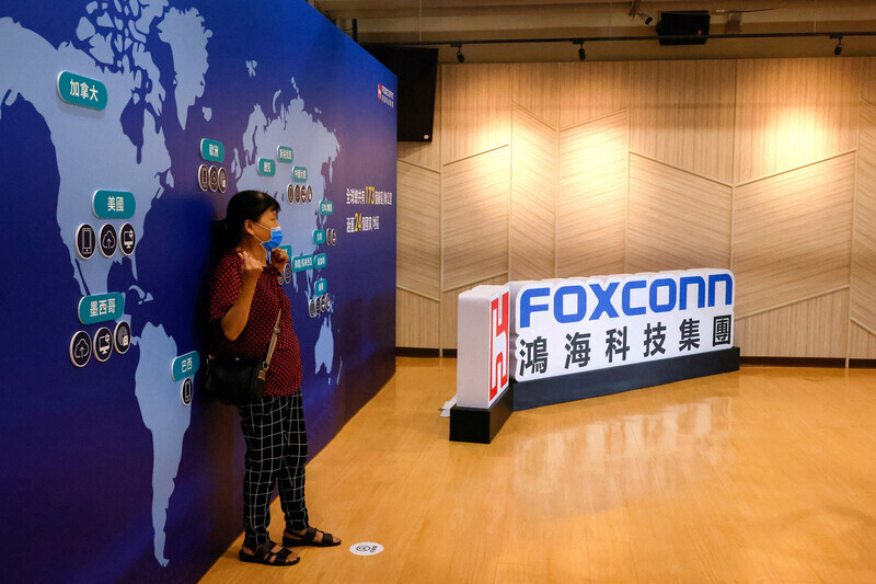 A Foxconn shareholder poses for a photo following a shareholders meeting in Taiwan in May. (Reuters/Yonhap)