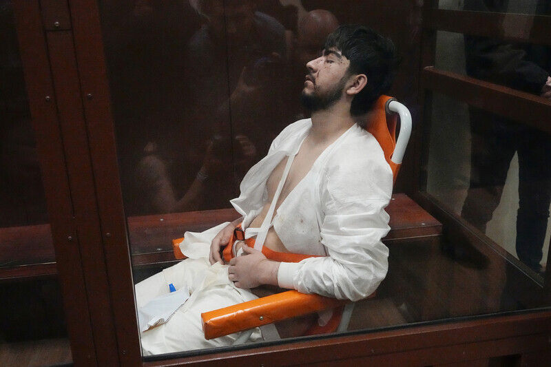 A suspect in the terror attack on Crocus City Hall in Moscow on March 22, 2024, sits in a courtroom in a wheelchair on March 24. (AP/Yonhap)