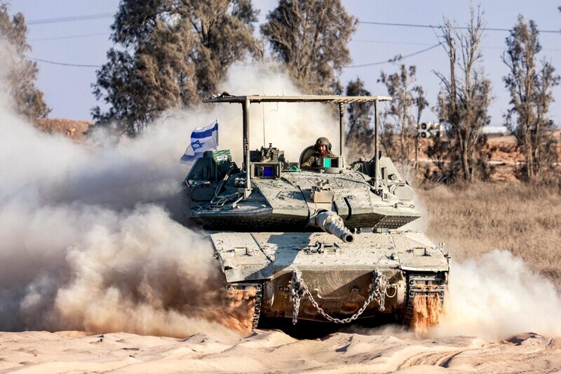 An Israeli tank drives along the border of the Palestinian territory of Gaza on July 14, 2024. (AFP/Yonhap)
