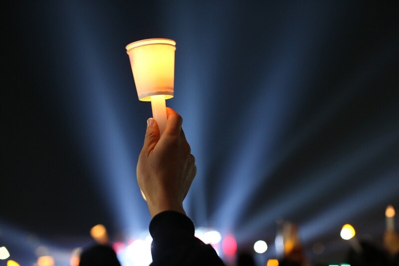 A citizen holds a candle at the 20th candlelight demonstration on March 11. The theme of the demonstration was