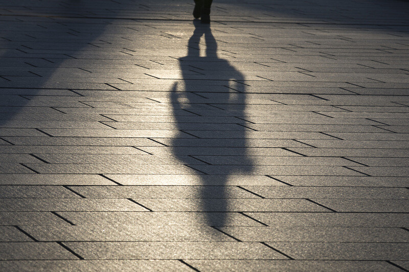 A student casts a shadow as they walk across a campus in Seoul.