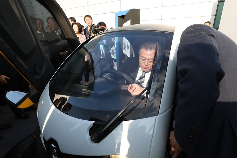 South Korean President Moon Jae-in looks over an electric car at the Hyundai Kia Namyang R&D Center in Hwaseong