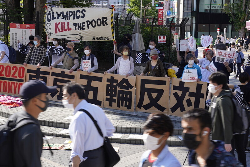 Demonstrators are protesting against the Olympics in Tokyo on Sunday, holding signs reading, “the Olympics kill the poor.” (EPA/Yonhap News)
