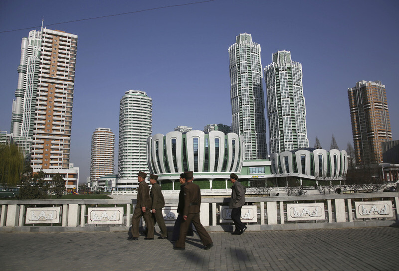 Pyongyang residents admire a newly constructed apartment complex after the opening ceremony for Ryomyong Street on Apr. 13