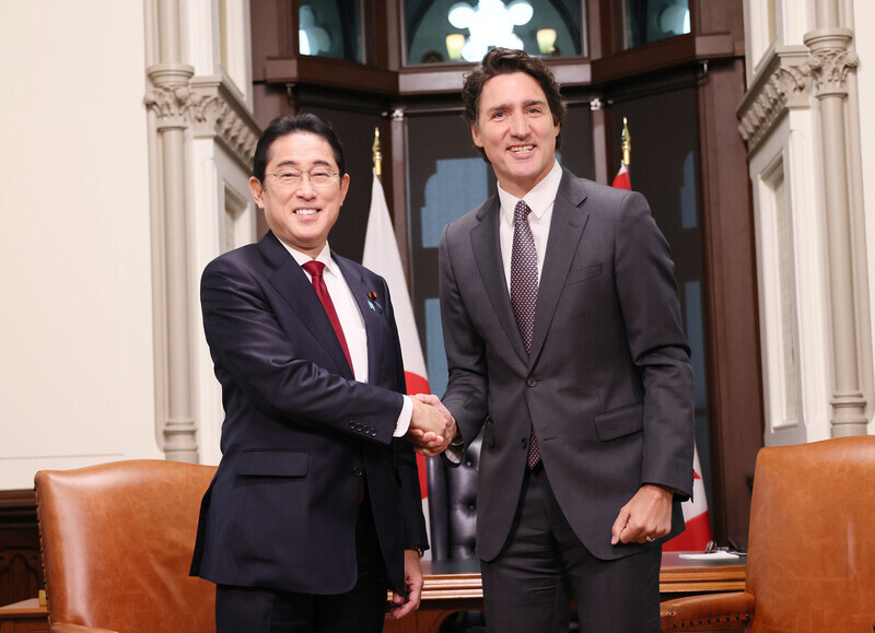 Prime Minister Fumio Kishida of Japan shakes hands with Prime Minister Justin Trudeau of Canada during a summit in Ottawa in January 2022. (courtesy of the prime minister’s office of Japan)