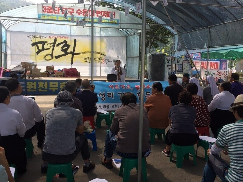 Religious hold a prayer meeting in front of the Soseong Village Community Center in Seongju County