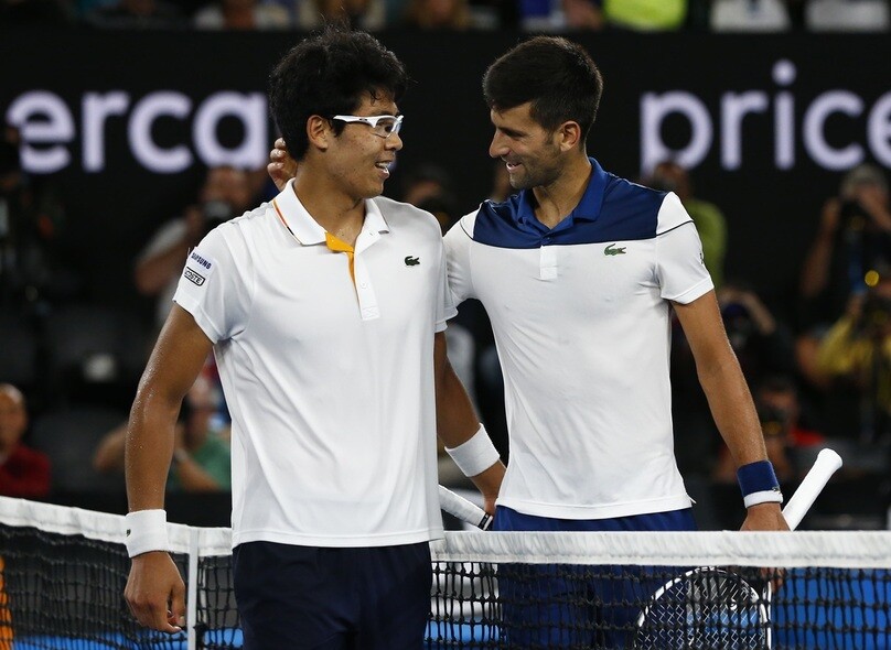 Hyeon Chung speaks with Novak Djokovic after their fourth-round Australian Open match