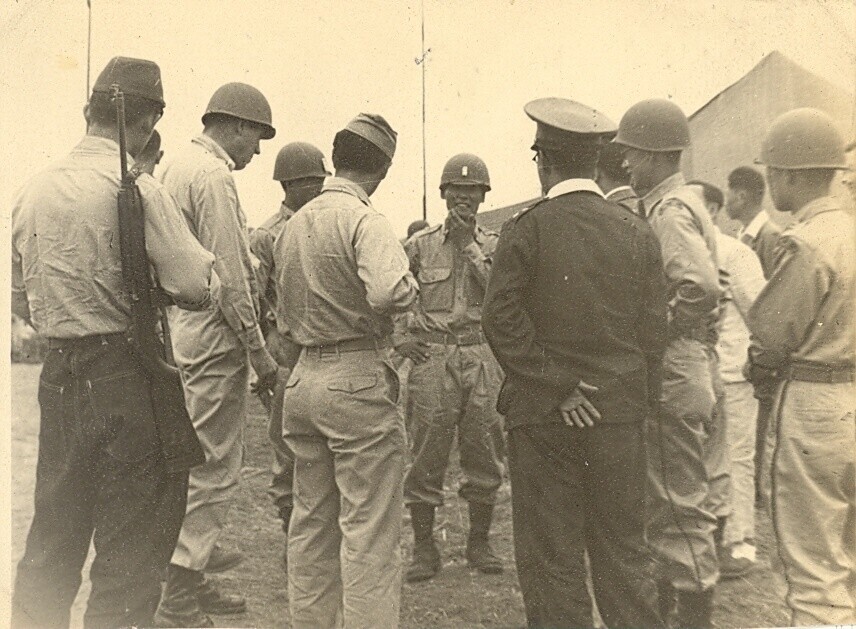 Officers including the commander of the 11th Regiment of the Korea Constabulary (predecessor of the ROK Army) speak with US military advisors in June of 1948 on Jeju Island.