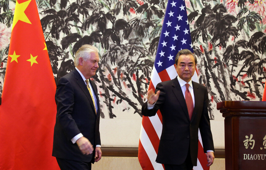 US Secretary of State Rex Tillerson and Chinese Foreign Minister Wang Yi leave after a press conference at the Diaoyutai State Guesthouse in Beijing