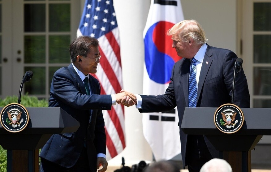 President Moon Jae-in shakes hands with US President Donald Trump during a joint press conference at the White House Rose Garden in Washington DC after their summit