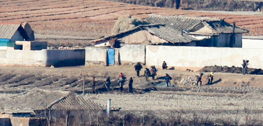 North Koreans in rural Kaepung, in Hwanghae Province, can be seen working in fields from the Ganghwa Peace Observatory in South Korea’s Incheon area on Feb. 20, when the North fired two rounds from its “super-large” multiple rocket system.